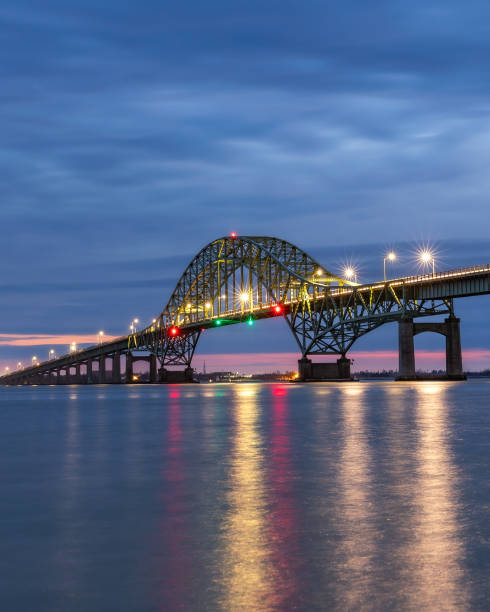 istock Dramatic blue hour stormy scene over a long steel tied arch bridge 1468997267