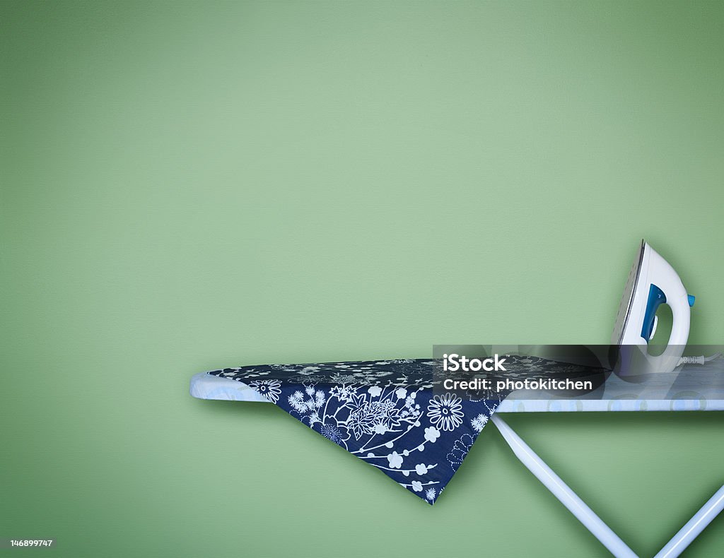 Iron Away Iron sitting on an ironing board Blue Stock Photo