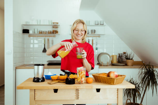 istock Young woman making fresh smoothie 1469004981