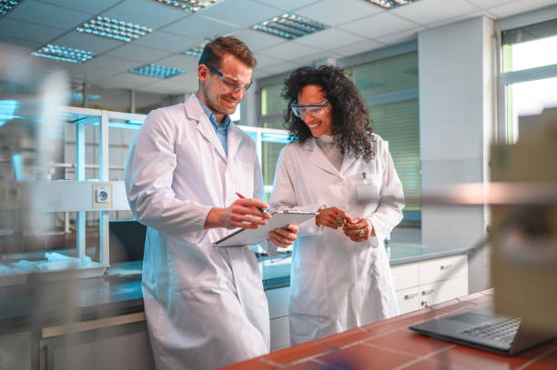 istock Mid Adult Mixed Team of Scientists in a Lab 1469005120