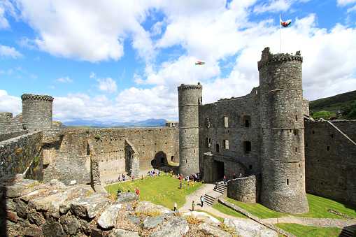 Ultra-wide angle view of the inner ward with large round towers at each corners. Harlech Castle, Gwynedd, Wales.