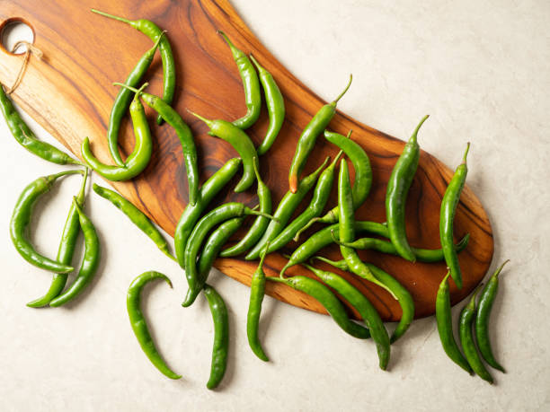 istock fresh green chillies on chopping board 1469008372