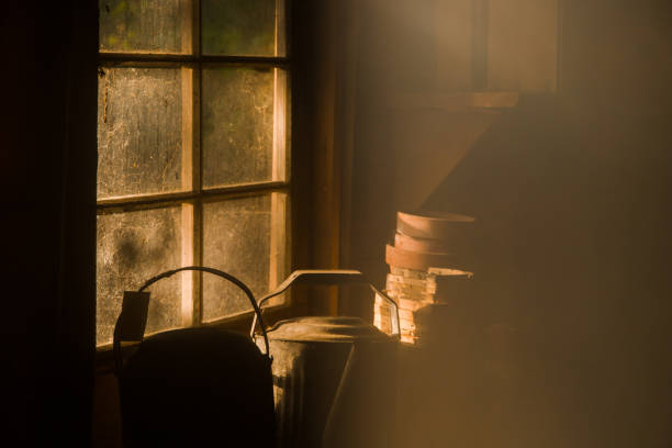Antique jug hanging on a wall casts a shadow.