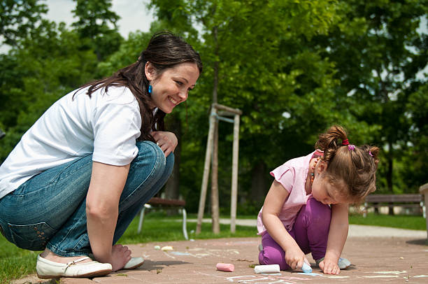 istock Mother with child drawing on sidewalk 146901357