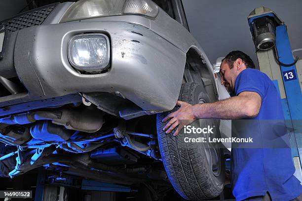 Tire Change Stock Photo - Download Image Now - Adults Only, Auto Mechanic, Auto Repair Shop