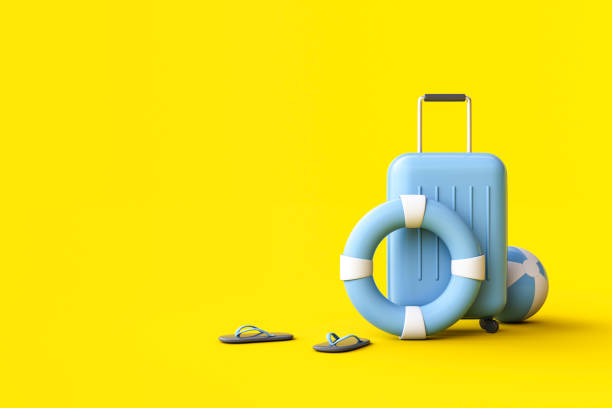 Suitcase, ball, swim ring and Flip flops on yellow background