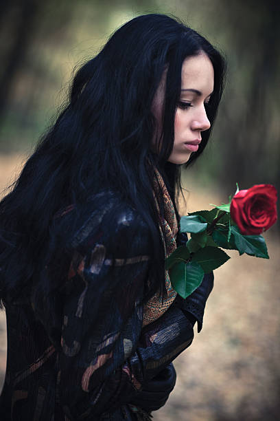 istock Young brunette woman with red rose portrait 146901577
