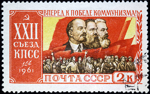 Communist stamp A good example of defunct communist iconography from the Soviet Union, showing Lenin, Engels, and Marx against the red flag and mass of workers. vladimir lenin photos stock pictures, royalty-free photos & images