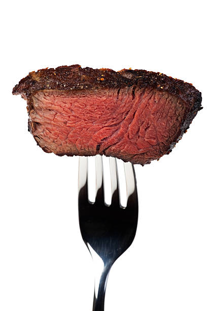 istock Cooked piece of steak on a fork on a white background 146901751