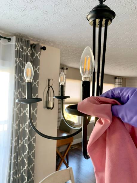 istock Dusting chandelier with glove and pink rag 1469019810