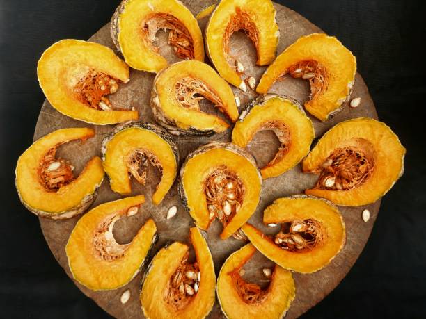 istock Cutting and slicing Pumpkin fruit on cutting board - food preparation. 1469027505