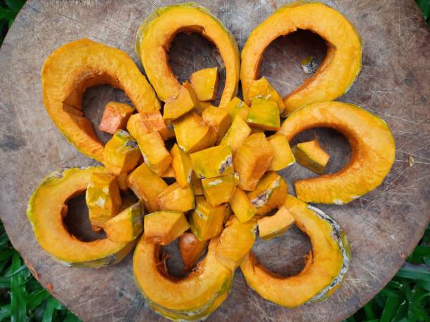 Cutting and slicing Pumpkin fruit on cutting board - food preparation.