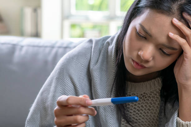 istock Sick young Asian woman at home on the sofa. 1469030008