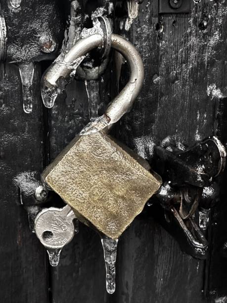 Lonely red padlock of love on a gray pipe, in winter. High quality photo