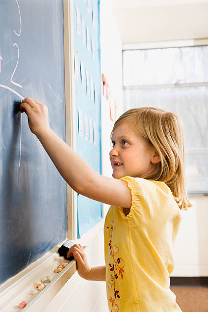 istock Girl Writing on Blackboard 146903508