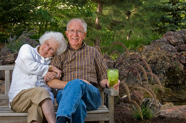 istock Elderly man and woman sitting on a bench 146904141