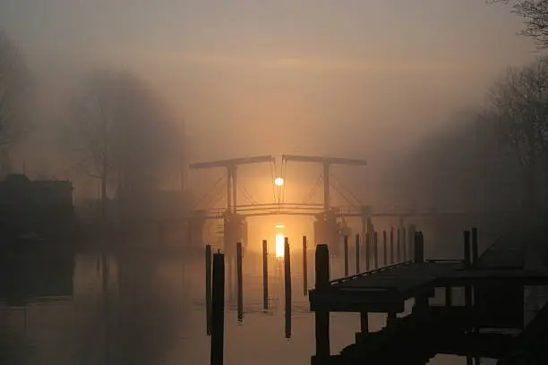 Skinny bridge in the Dutch city Weesp in the early morning at sunrise.