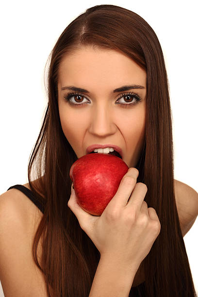 The girl eats a apple stock photo