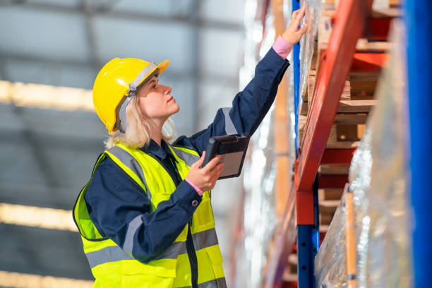 The warehouse worker is using a digital barcode reader to check the code of containers on carton boxes in the factory warehouse. The warehouse worker is using a digital barcode reader to check the code of containers on carton boxes in the factory warehouse. bar code reader radio frequency identification warehouse checklist stock pictures, royalty-free photos & images