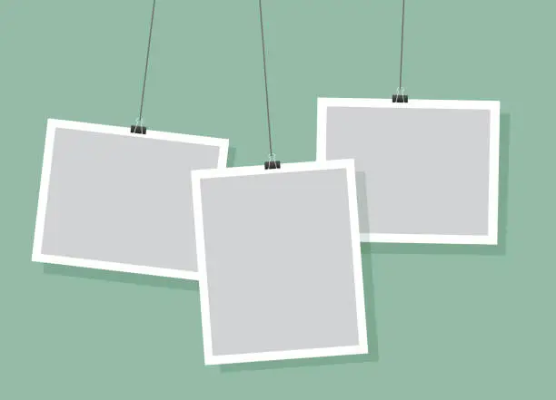 Vector illustration of Simple hanging photo frames design, light green vector background