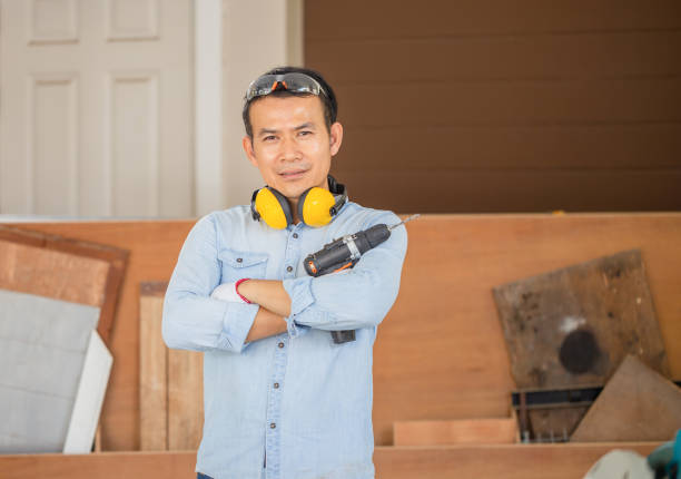 Carpenter holding electric screwdriver in the workshop, Technical man doing woodwork in carpentry