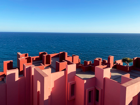 Calpe, Spain - 6 November 2022: The postmodern complex building 'La Muralla Roja', the red wall, by architect Ricardo Bofill