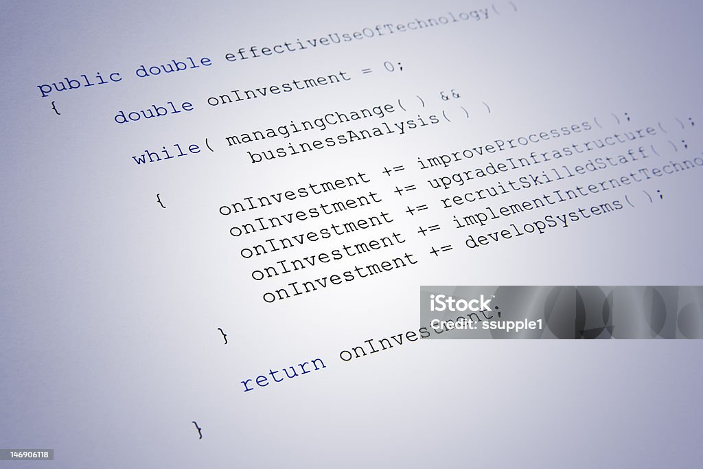 Java code showing return on investment of IT to business Technology and business concept. Java source code on a paper printout. The code contains a class that calculates the return on investment of IT to business. Blue Stock Photo