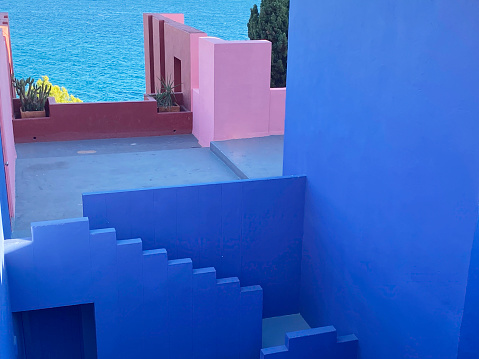 Calpe, Spain - 6 November 2022: The postmodern complex building 'La Muralla Roja', the blue wall, by architect Ricardo Bofill