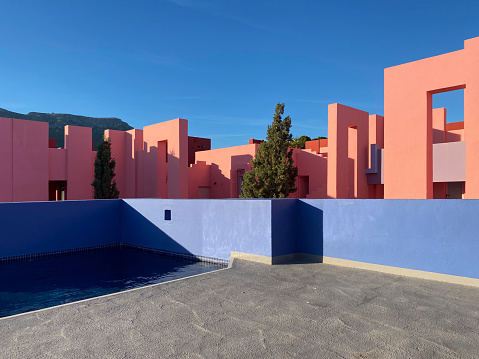 Calpe, Spain - 6 November 2022: The postmodern complex building 'La Muralla Roja', the red wall, by architect Ricardo Bofill