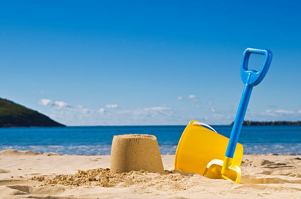 Spade and bucket at the beach stock photo