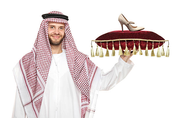istock Arab person holding a pillow with shoe on it 146906255