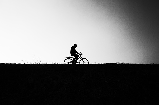 Cyclist on Sidney Street, Cambridge, Cambridgeshire, England, UK.