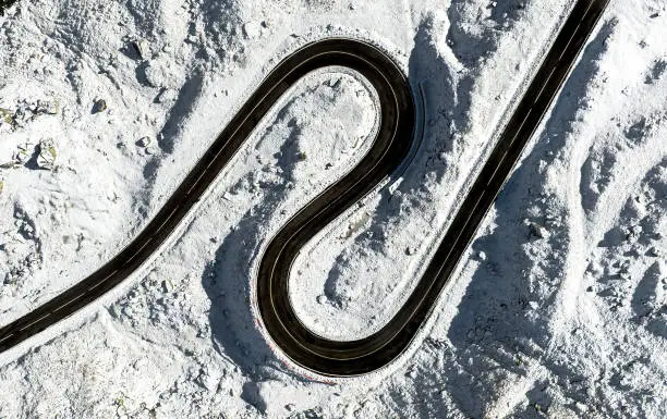 Aerial view of a twisted road in winter transfagarasan romania. Curvy winding road.