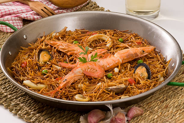 Spanish cuisine. Seafood spaghetti casserole. Fideua. stock photo