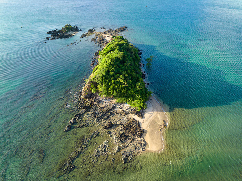 Beautiful Beach on  Koh Raeng Island in the Andaman Sea situated near the Island of Koh Lanta in warm light close to sunset. Aerial Drone Point of View towards the tiny natural  beach and island. Koh Raeng, Ko Lanta, Andaman Sea, Krabi Province, Thailand, Southeast Asia