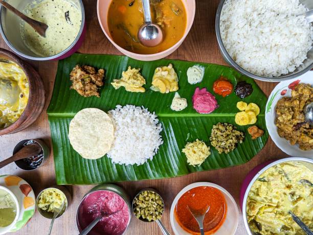 traditional south indian food platter traditional south indian food platter with rice and other variety food items served in a banana leaf for a festival or occasion kerala south india stock pictures, royalty-free photos & images