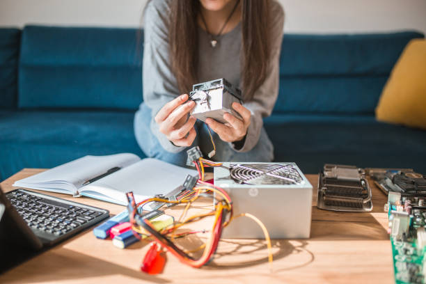 istock Unrecognizable female student learns about computer parts during online education: learn about cooler, computer power supply, computer hardware 1469068145