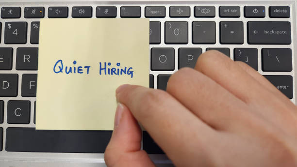 istock A person pointing at a note with  words Quiet Hiring written on 1469069474