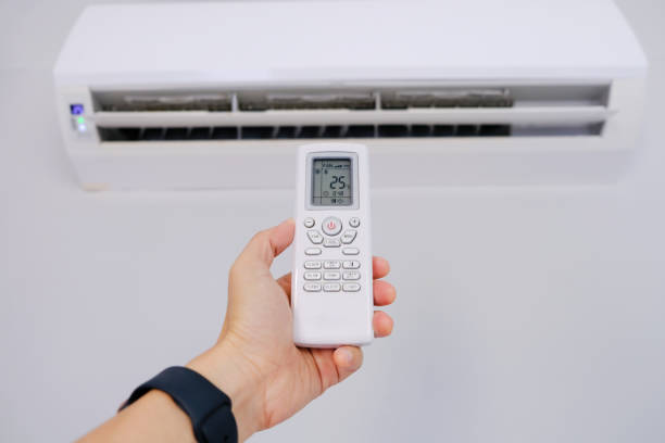 istock Man's hand using remote control open The air conditioner is cooled to 25 degrees Celsius in his bedroom. Health concepts and energy savings 1469069881