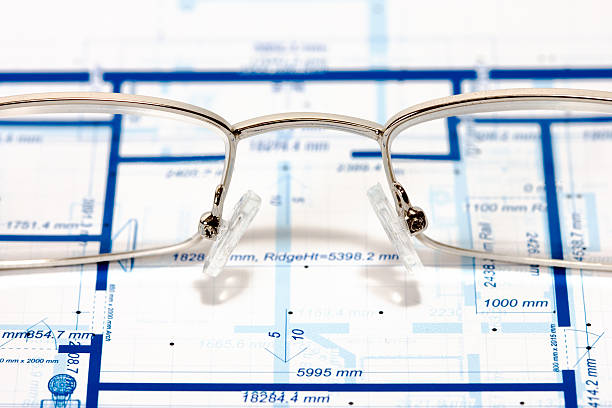 Blueprint for a house and eyeglasses stock photo