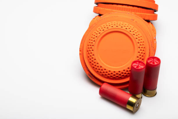 istock Stack of Clay shooting target with red shotgun shell bullets on white background 1469074533