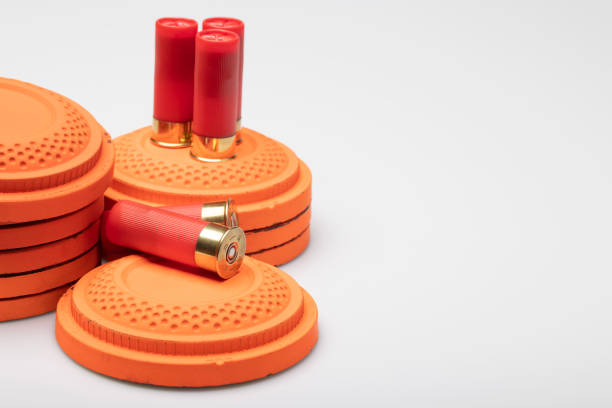 istock Clay shooting targets with shotgun shell bullets on white background 1469074534