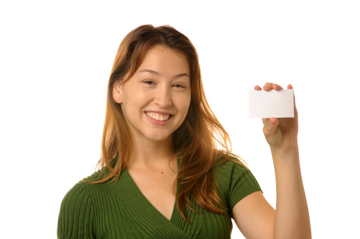 Young beautiful woman holding a blank credit card size paper.