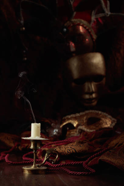 istock Still life with an extinguished candle and carnival masks. 1469081671