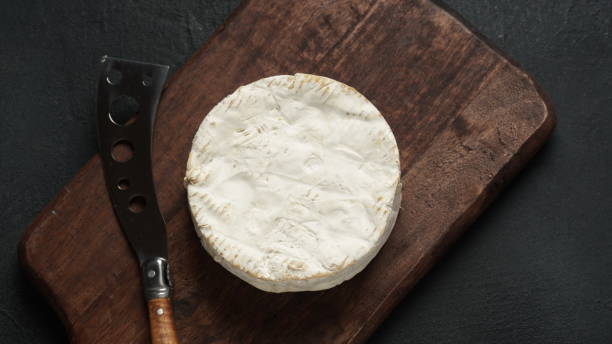 istock Camembert de Normandie cheese  on cutting board with knife 1469082291