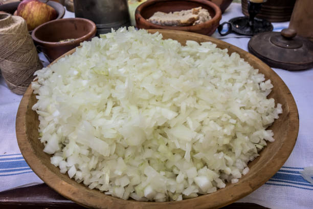 istock Wooden rustic plate with finely chopped onion close-up on the table 1469082319