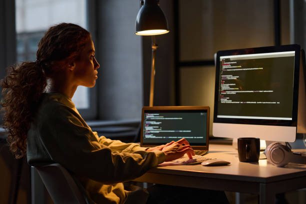 istock Woman working on computer in dark office 1469092118