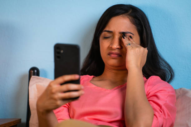 istock sleepy young girl rubbing eyes while using mobile phone during late night at home - concept of smartphone addiction, healthcare and insomnia 1469092687