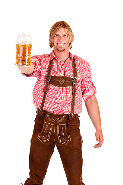 Happy man with leather trousers (lederhose) holds Beer Fest beer stein stock photo