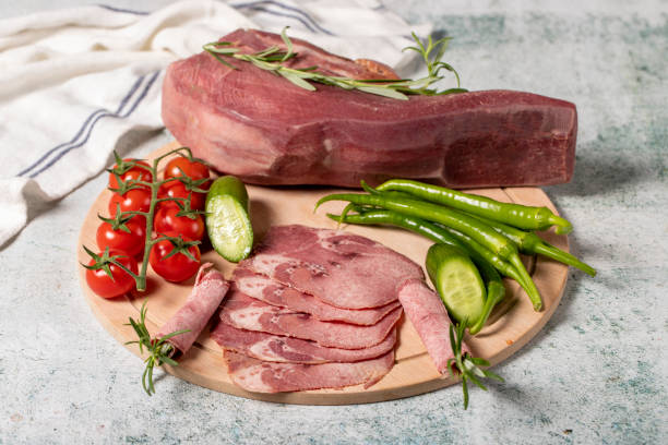 smoked beef tongue. sliced smoked veal tongue on wooden cutting board. delicious smoked meat. local name fume dana dil - smoked tongue imagens e fotografias de stock